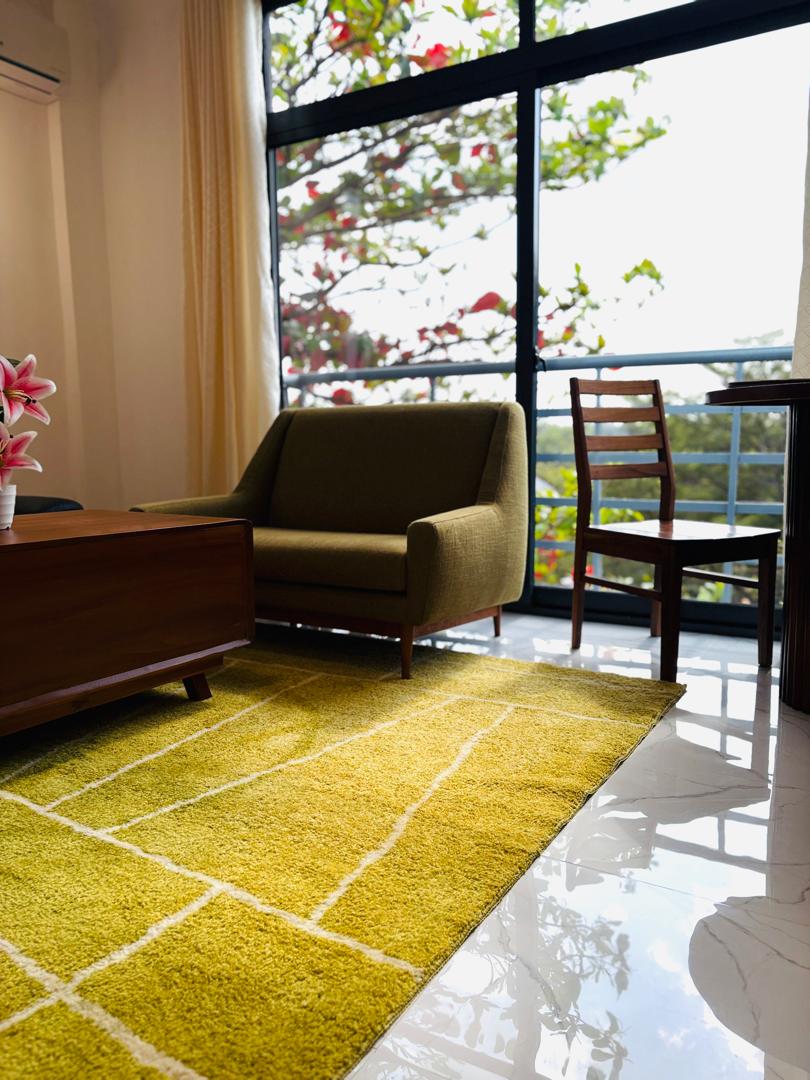 Owners Stays lounge beside a leafy private balcony